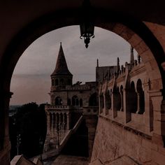 an archway leading to a castle with a clock tower