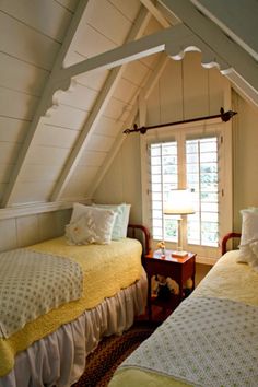 two beds in a room with white walls and yellow bedding on top of them