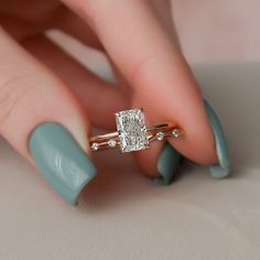 a woman's hand with two rings and a ring on top of her finger