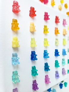 there are many gummy bears arranged on the wall next to each other in different colors