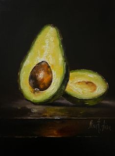 an acrylic painting of two avocados on a black surface with one half cut in half