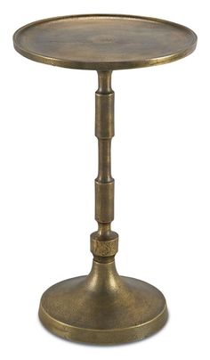 an antique brass table with two legs and a round top, on a white background