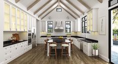 a large kitchen with white cabinets and black counter tops, along with wooden flooring