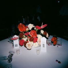 a white table topped with red and white flowers