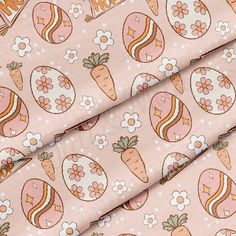 the fabric is pink with carrots and flowers on it