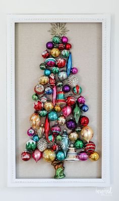 a christmas tree made out of ornaments in a frame