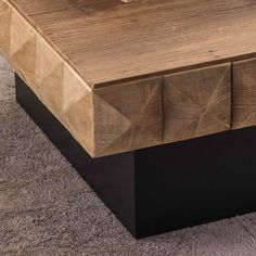 a close up of a coffee table with drawers on it's sides and carpeted floor