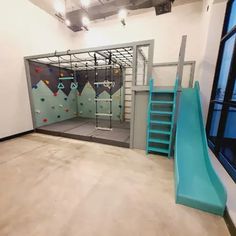 an indoor climbing wall and play area in a building