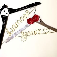 a pair of scissors with the word dance and two roses attached to them, sitting next to each other