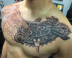 a man with a tattoo on his chest