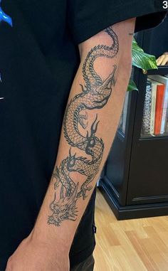 a man with a dragon tattoo on his arm