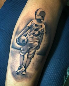 a man's leg with a football player holding a ball and helmet on it