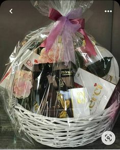 a white basket filled with chocolates and wine