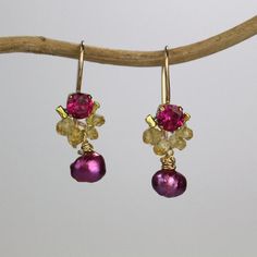 These handcrafted dancer earrings are petite, delicate and whimsical. The unique copper bezel setting showcases a bright pink corundum zircon. Beautiful and elegant citrine gemstones are hand woven and a lovely pink pearl dangles gently. These romantic and colorful dancer earrings seem to come straight from a fairytale!They're the perfect pair of earrings to give your special someone! The hook is made of gold filled. The earring's hook can be made with sterling silver or solid gold incase of all Unique Festive Earrings With Ear Wire, Handmade Briolette Pearl Earrings For Gift, Fusion Style Wire Wrapped Earrings For Gift, Wire Wrapped Fusion Earrings For Gift, Whimsical Gold Wire Wrapped Earrings, Whimsical Wire Wrapped Earrings For Party, Handmade Briolette Earrings For Party, Whimsical Gold Teardrop Earrings, Whimsical Wire Wrapped Drop Earrings