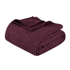 the maroon blanket is folded and ready to be used