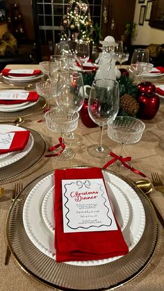 a table set for christmas dinner with place settings