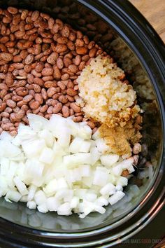 the ingredients for slow cooker baked beans in a crock pot with text overlay