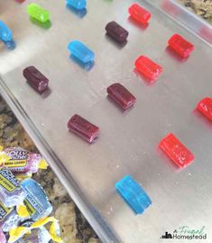 candy candies are lined up on a cookie sheet