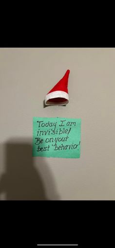 a santa hat is on top of a sign that says today i am trying to try and die if you're on your best behavior