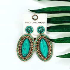 Beaded oval earrings in gold and turquoise. These earrings include a big center turquoise stone. These earrings are pictured on a white background with green leaves behind them. Gold Bead Earrings, Giddy Up Glamour, Teal And Gold, Turquoise Stone, Gold Beads, Beaded Earrings, Statement Earrings, Turquoise Necklace, Turquoise