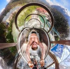 a man riding on the back of a metal roller coaster