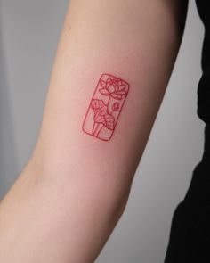 a woman's arm with a red ink drawing of flowers in a jar on it