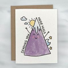 a greeting card with an illustration of a purple mountain and stars on the top that says,