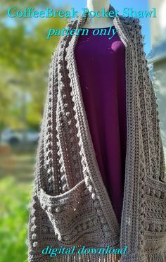 a woman's cardigan with fringes on the front and back, sitting on top of a mannequin