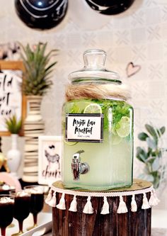 a glass jar filled with liquid sitting on top of a table