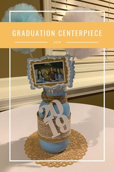 the graduation centerpiece is decorated with blue and white decorations