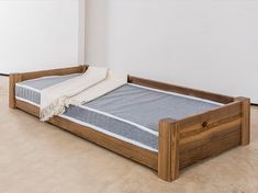 a wooden bed frame with a mattress on it