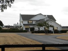 a large white house sitting on the side of a road