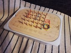 a wooden board with many different colored pieces on it and some wires in the middle