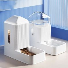 a white bird feeder sitting on top of a counter next to two containers filled with food