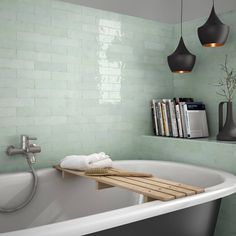 a bathtub with bookshelves above it and a book shelf in the corner