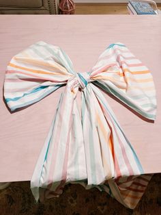 a pink table topped with a bow tie on top of it's headband