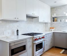 a kitchen with white cabinets and stainless steel appliances