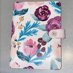 a wallet with flowers painted on it