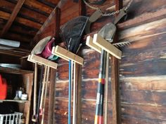 there are many different items hanging on the wall in this room, including brooms and rakes