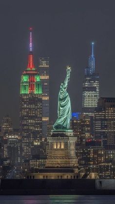 the statue of liberty is lit up in green and red