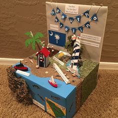 a cardboard box that is sitting on the floor next to a sign and some decorations