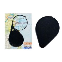 a magnifying glass sitting on top of a map next to it's case