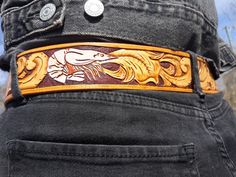 "I make hand tooled custom leather belts, starting at $159.00.  I usually make belt that are 1.5\" wide with a 1.5\" buckle. * Please do not purchase a custom belt from this post, but send me a message with your belt size and explaining what you would like and I will give you a price. HOW TO FIND YOUR BELT SIZE: The best way to find your belt size is to measure a belt that you already have. Measure from the inside edge of the buckle (see graphic in photos) to the hole that you wear the belt at m Custom Handmade Leather Belts, Handmade Custom Leather Belts, Tooled Belt, Custom Leather Belts, Tooled Leather Belts, Custom Belt, Tool Belt, Hand Tooled Leather, Suspender Belt