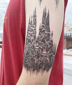 a man with a tattoo on his arm that has a cathedral in the middle of it