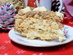 a piece of cake sitting on top of a white plate next to a pine cone