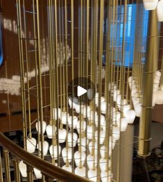 a bunch of balls that are inside of a metal cage on the stairs in a building