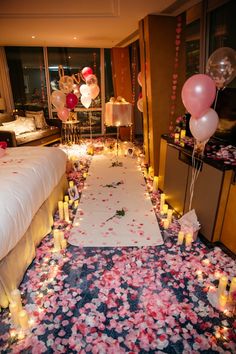 a room with candles and flowers on the floor