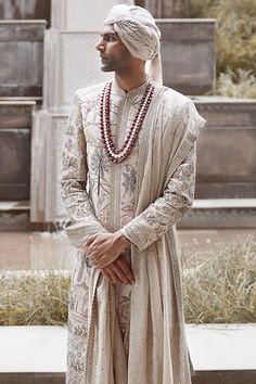 Cream raw silk sherwani crafted with all over 'Shikargah' pattern, multi color resham, aari, silver dabka, sequins, mirror and zardozi hand embroidery. Paired with jacquard kurta and straight pant. - Aza Fashions Raw Silk Straight Kurta Sherwani For Traditional Ceremonies, Raw Silk Sherwani For Traditional Ceremonies, Traditional Raw Silk Wear With Naqshi Detailing, Traditional Naqshi Raw Silk Traditional Wear, Transitional Traditional Wear With Naqshi Drape, Raw Silk Naqshi Bandhgala For Traditional Ceremonies, Traditional Sherwani With Traditional Patterns For Ceremonies, Eid Traditional Sherwani With Traditional Patterns, Transitional Sherwani With Traditional Patterns For Ceremonies