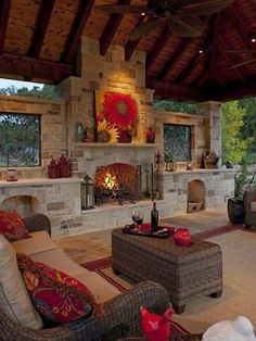 an outdoor living room with fireplace and seating