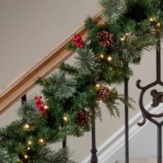 a christmas wreath is hanging on the banister